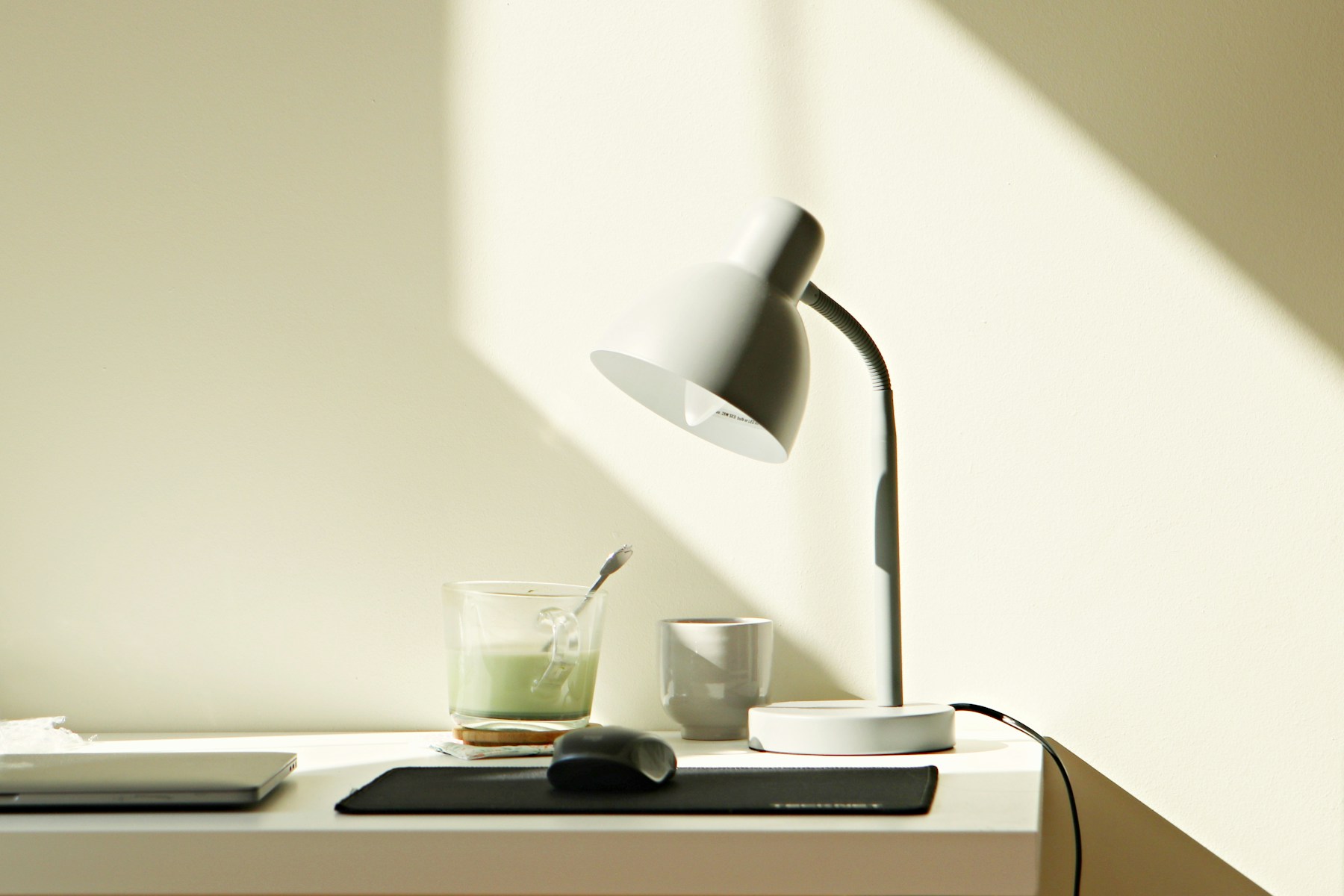 Desk with a lamp in afternoon sunlight